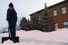 man shoving snow